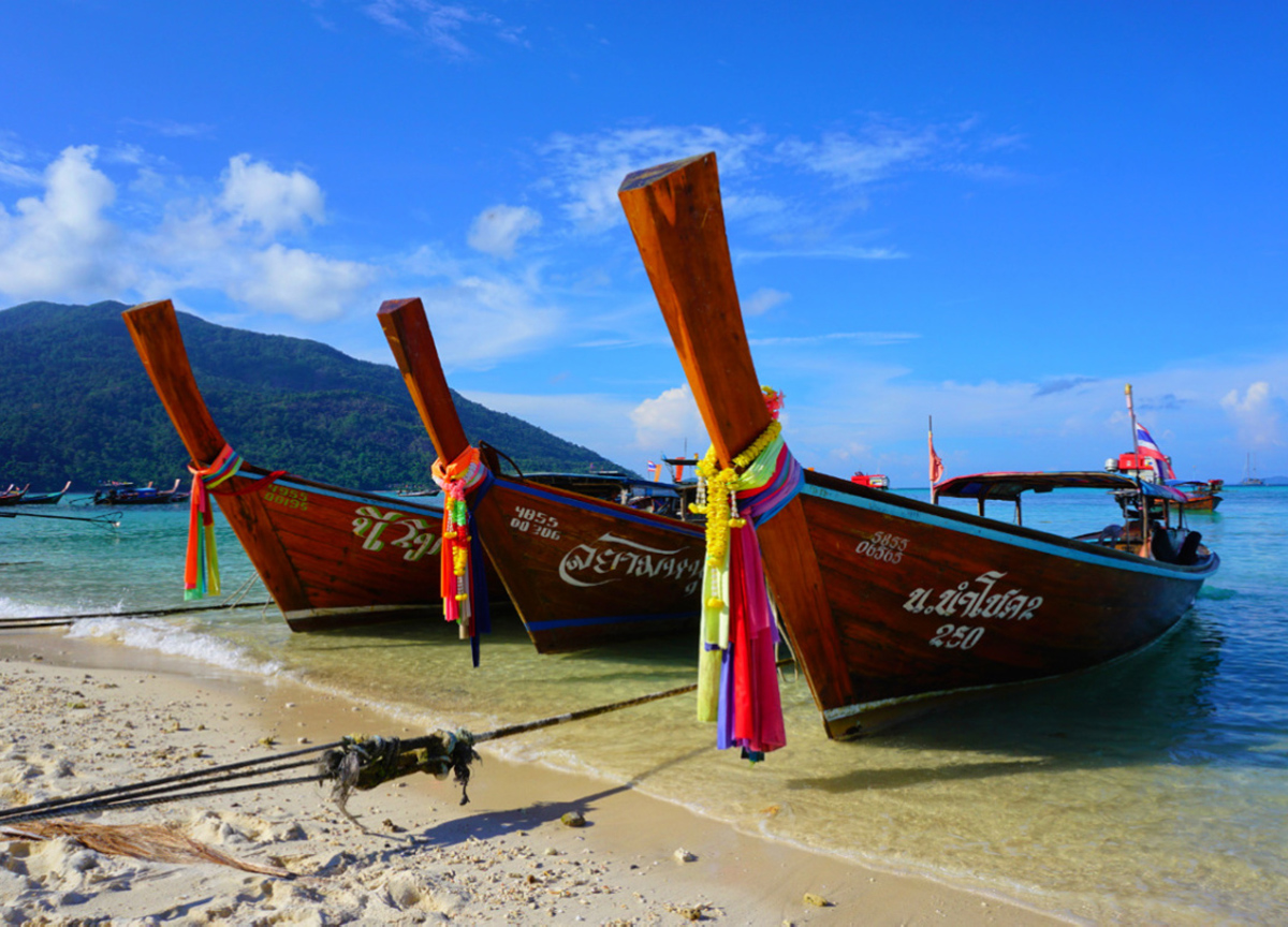 Pristine hidden beach in Thailand with crystal clear turquoise water and white sand, no tourists visible