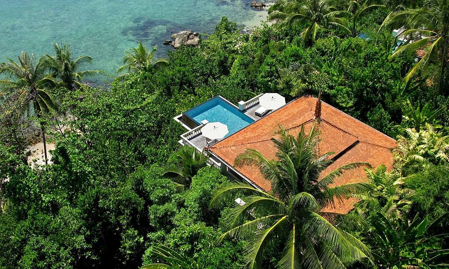 Aerial view of Trisara Resort in Phuket showcasing luxury villas and stunning location